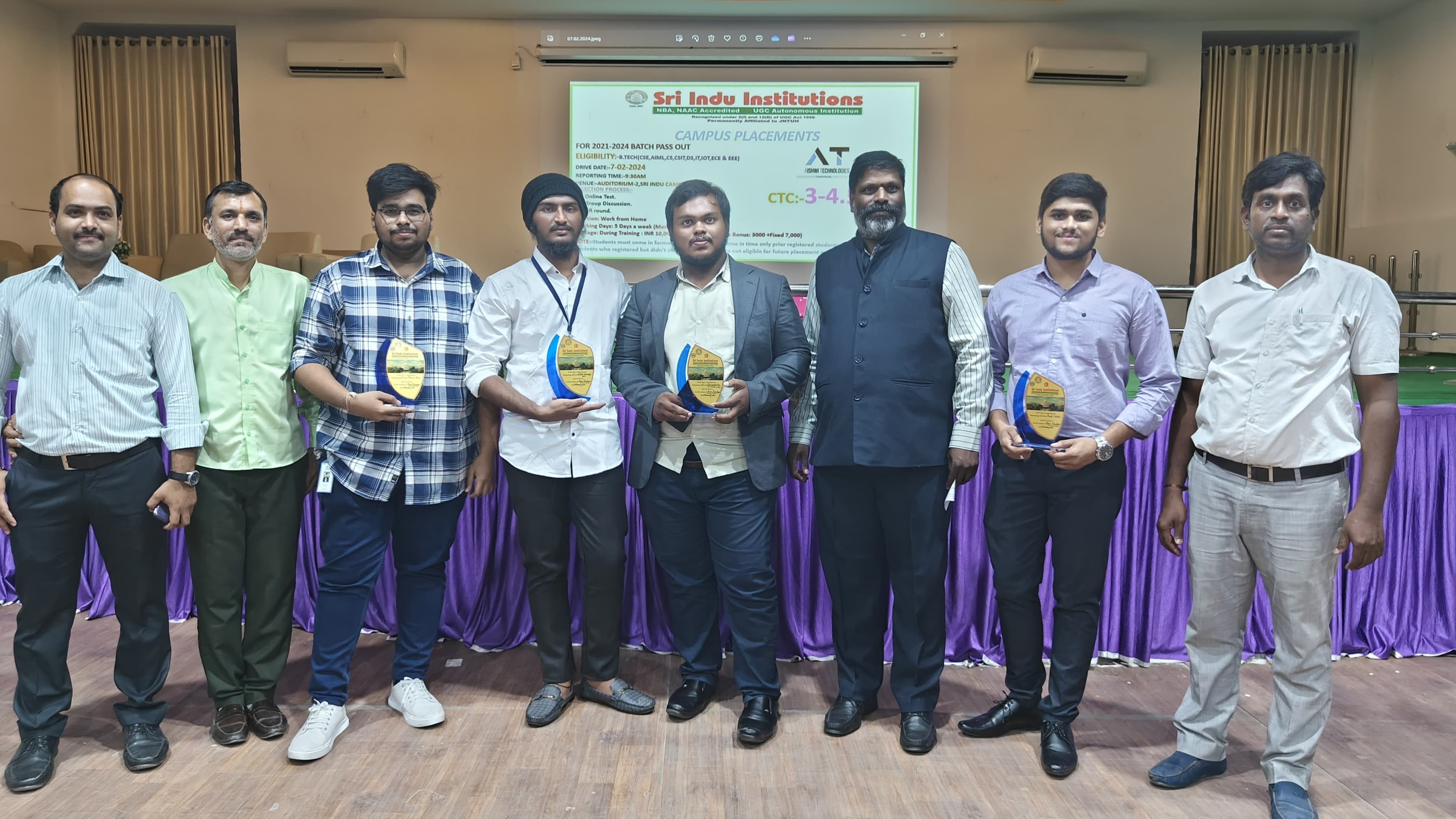 Sraventix-trained students holding placement trophies alongside campus recruiters at a Sri Indu Institutions placement drive