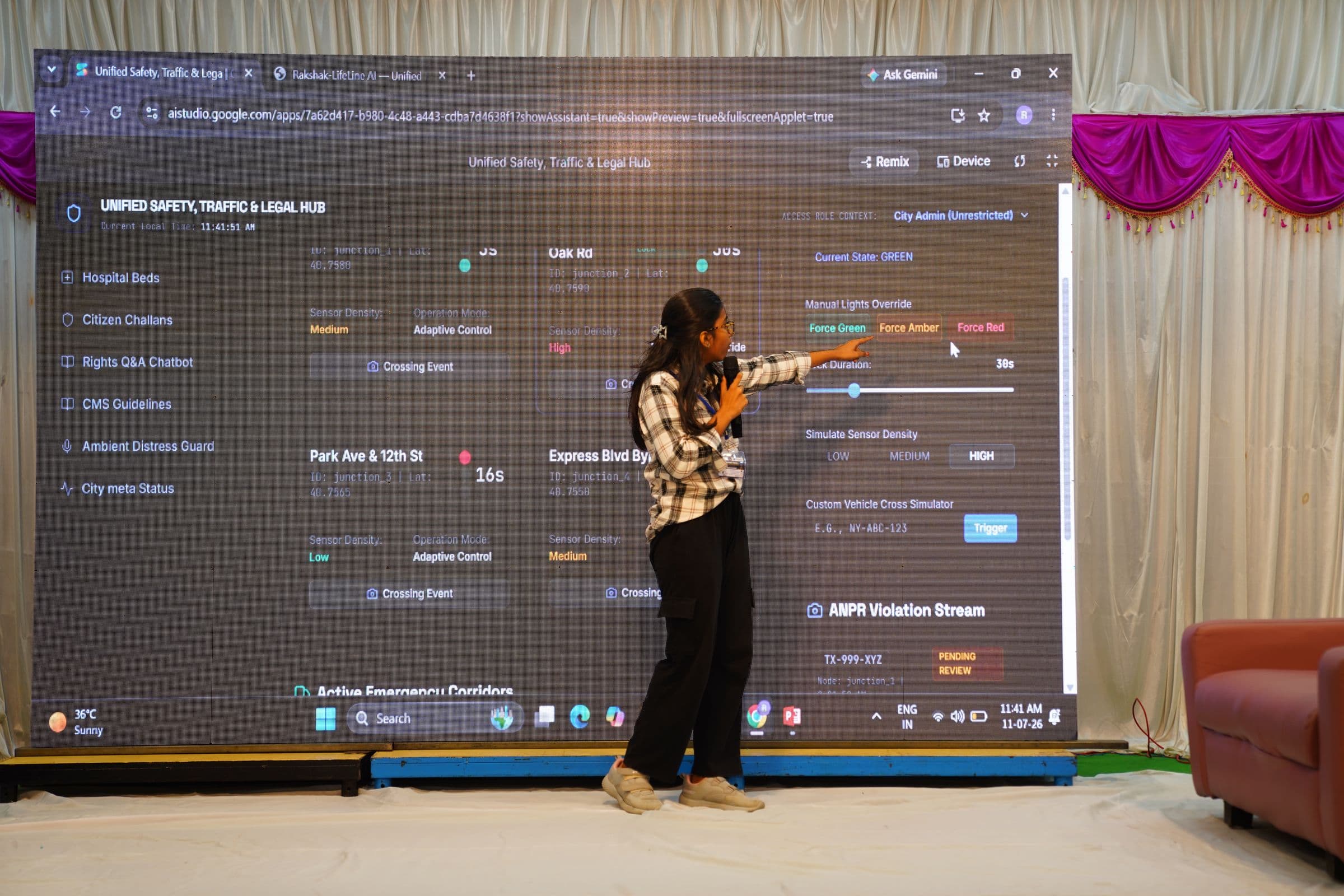 A participant presenting an AI-powered Unified Safety, Traffic & Legal Hub dashboard on stage