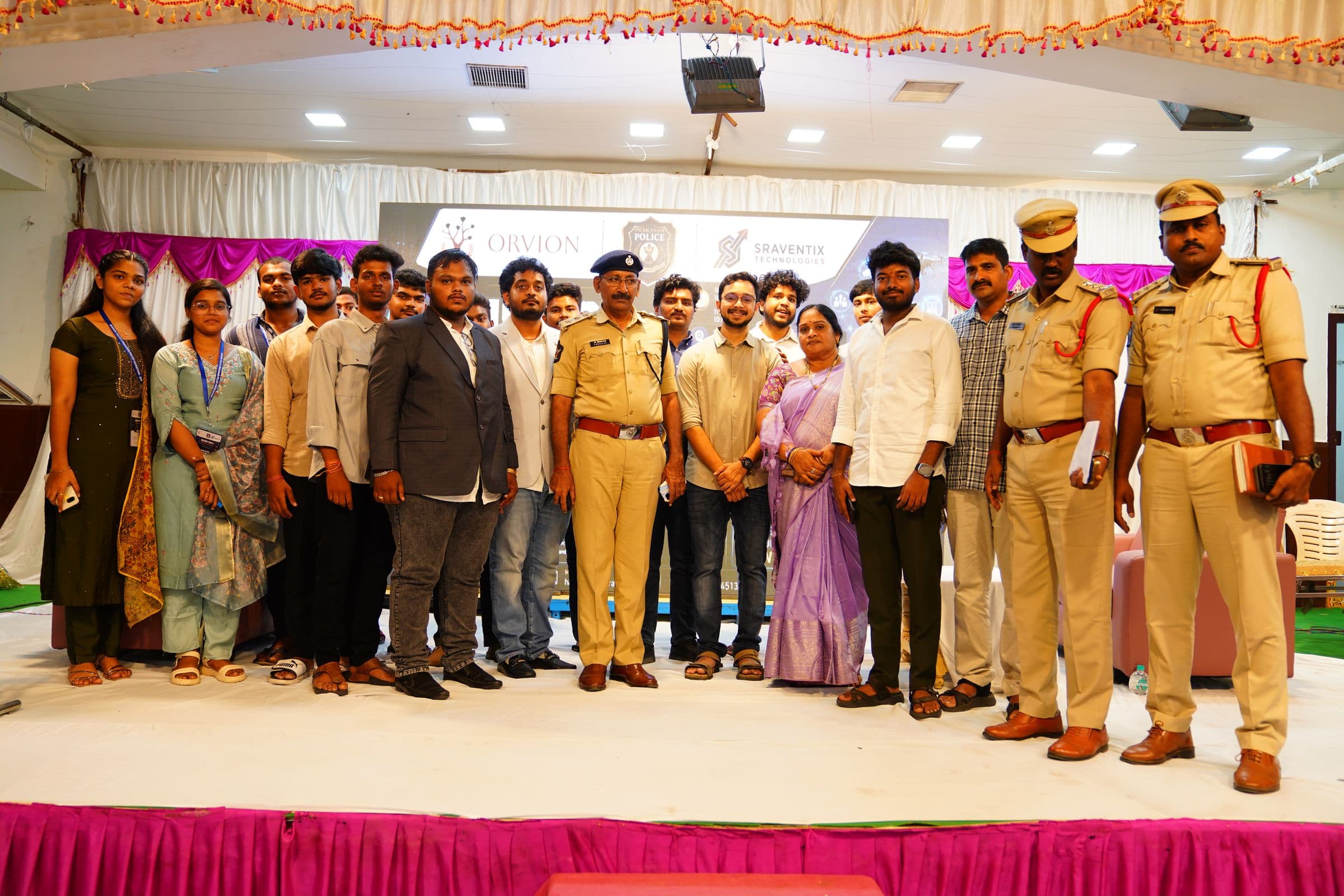 The Sraventix Technologies team with Prakasam Police officials and hackathon participants on stage
