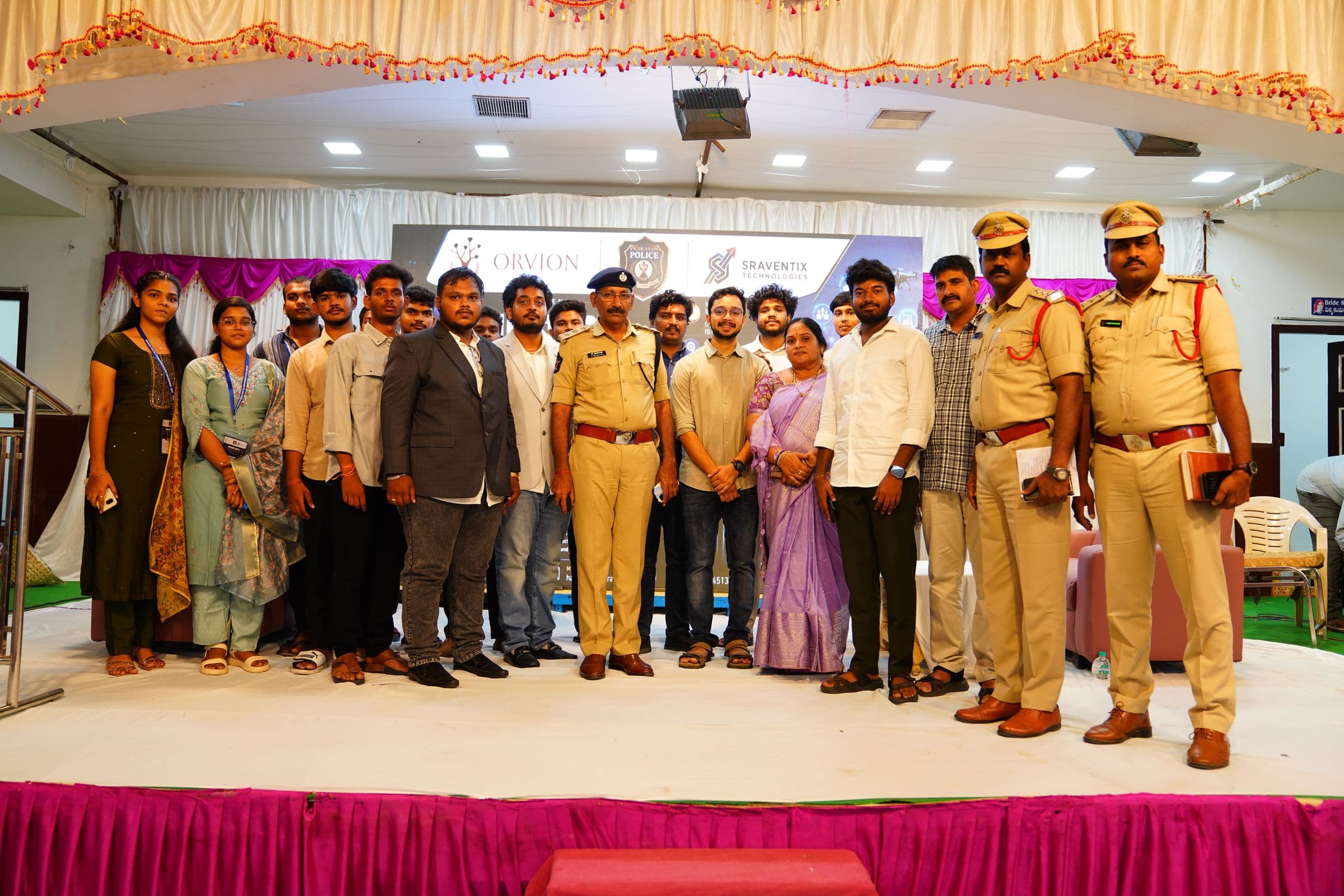 The Sraventix Technologies team on stage with senior Prakasam Police officials and the full cohort of hackathon participants